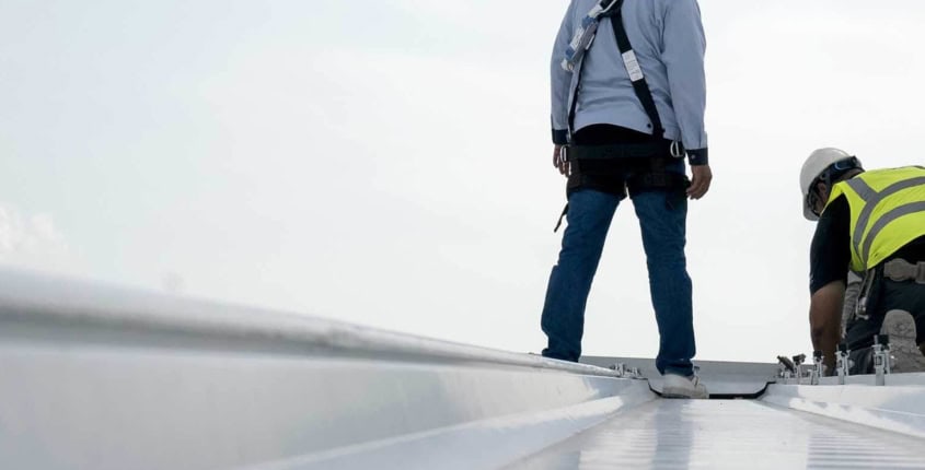 routine roof inspections, increasing longevity of your roof August Blog 2 two roofers performing routine inspection on top of roof