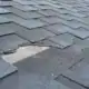 Close Up View Of Shingles Damaged From Hail Storm
