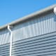 Commercial building roofing gutters and downspouts