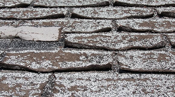 effects of extreme heat on residential roofs old warped shingles
