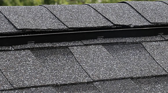 Residential sloped roofing ridge vent