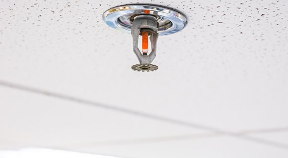 Sprinkler and tile misalignment before commercial flat roof collapse