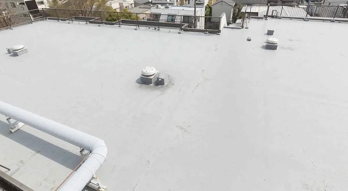 condo building with flat roofing system